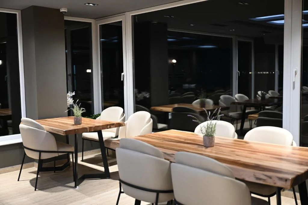 Restaurant dining area with live-edge walnut tables and lake views